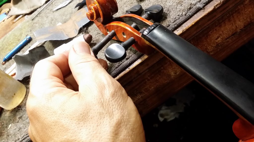 Master violin maker Olaf Grawert repairing a violin in Brisbane