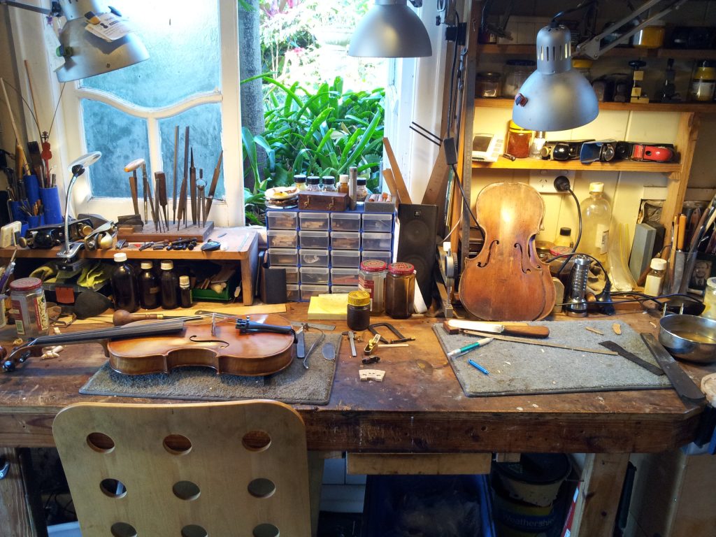 Master violin maker Olaf Grawert repairing a violin in Brisbane