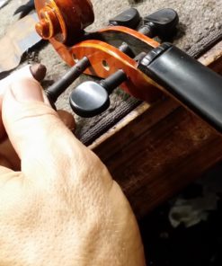 Master violin maker Olaf Grawert repairing a violin in Brisbane