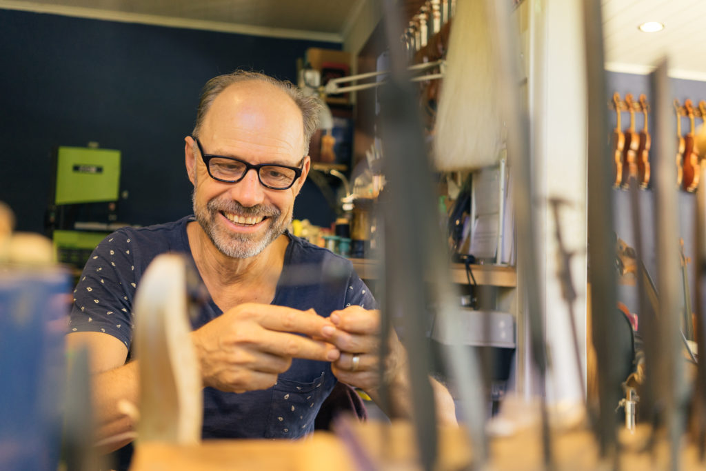 Master violin maker Olaf Grawert repairing a violin in Brisbane